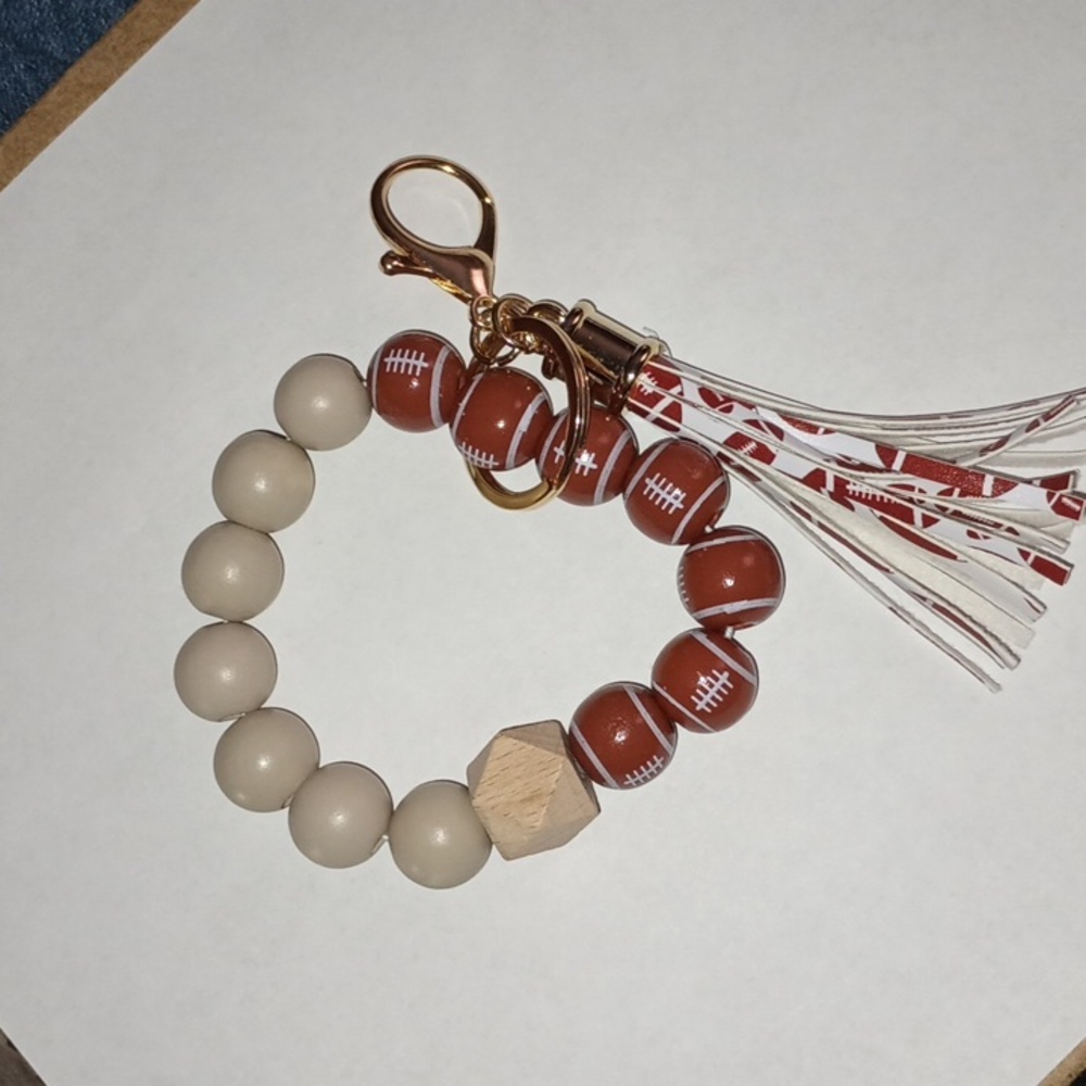 Wooden beaded football wristlet keychain with clip clasp
